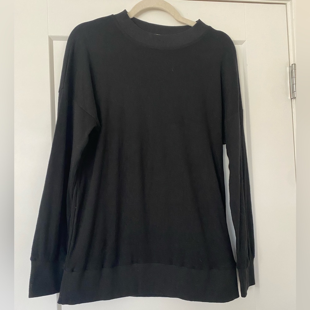Long sleeve black drop shoulder sweater.